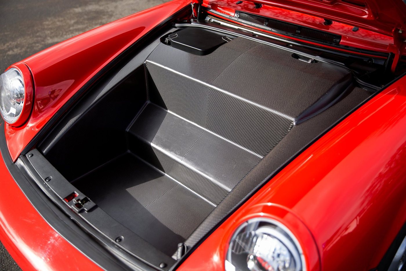 Stuttgart Classica carbon frunk insert installed in a red 964 front trunk